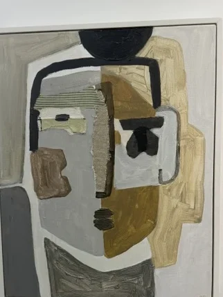 Fourth Life by Raquel Barrios, a mixed-media portrait assembled from grey, cream, brown, black, and striped fabric forms.