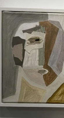 Inhabiting the Fragment II by Raquel Barrios, a small mixed-media profile in pale grey, cream, ochre, and brown.